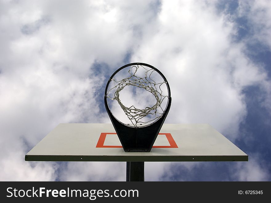 An outdoor basketball hoop from underneath. An outdoor basketball hoop from underneath