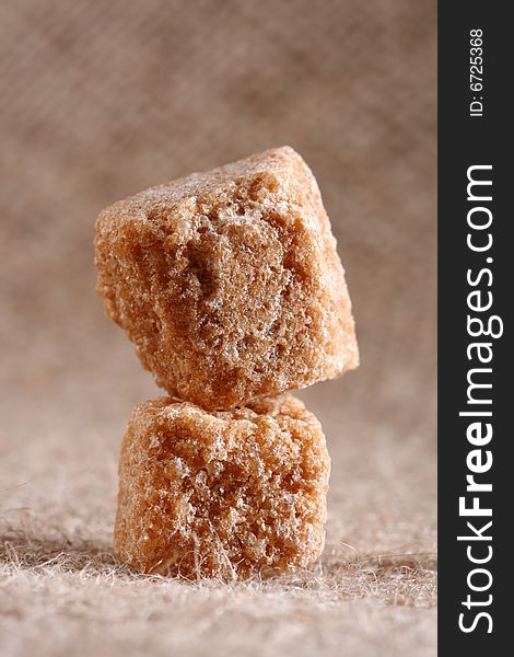 Two Brown Sugar Cubes On Hessian Background