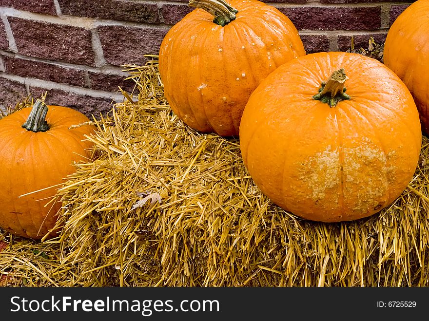 A shot of some pumpkins on a bale of straw. A shot of some pumpkins on a bale of straw