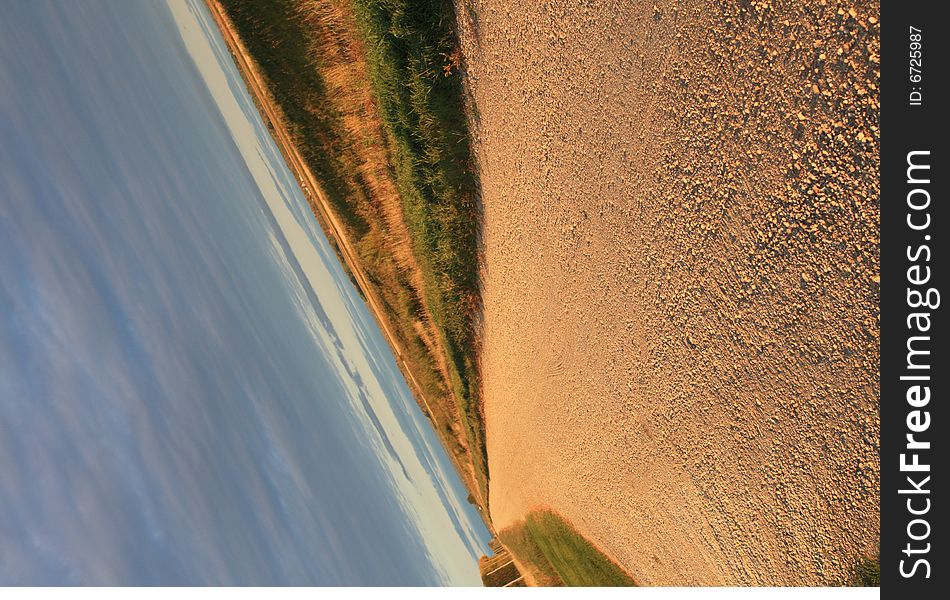 Slanted view of a gravel road.