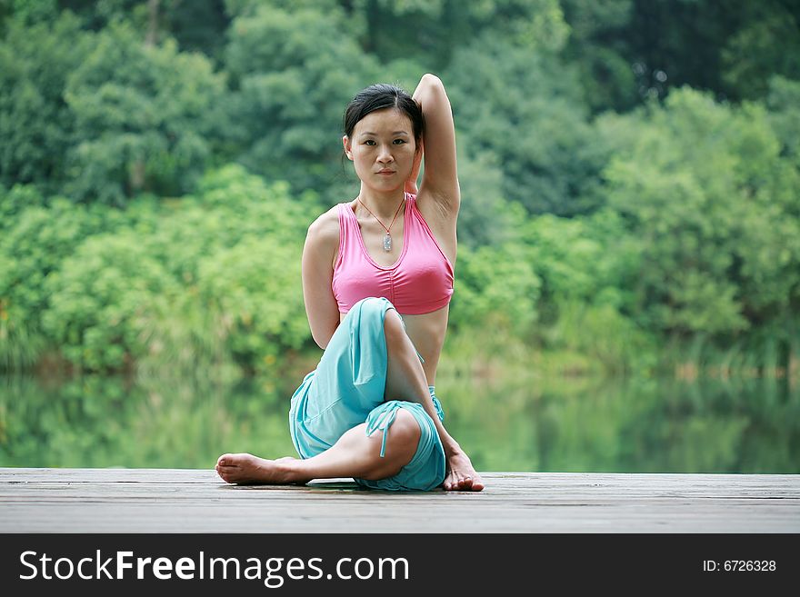 Young Chinese Woman Practicing Yoga Outdoor