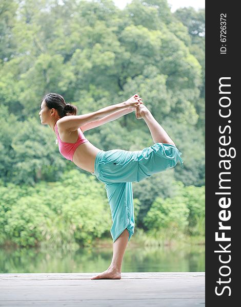 Young Chinese Woman Practicing Yoga Outdoor