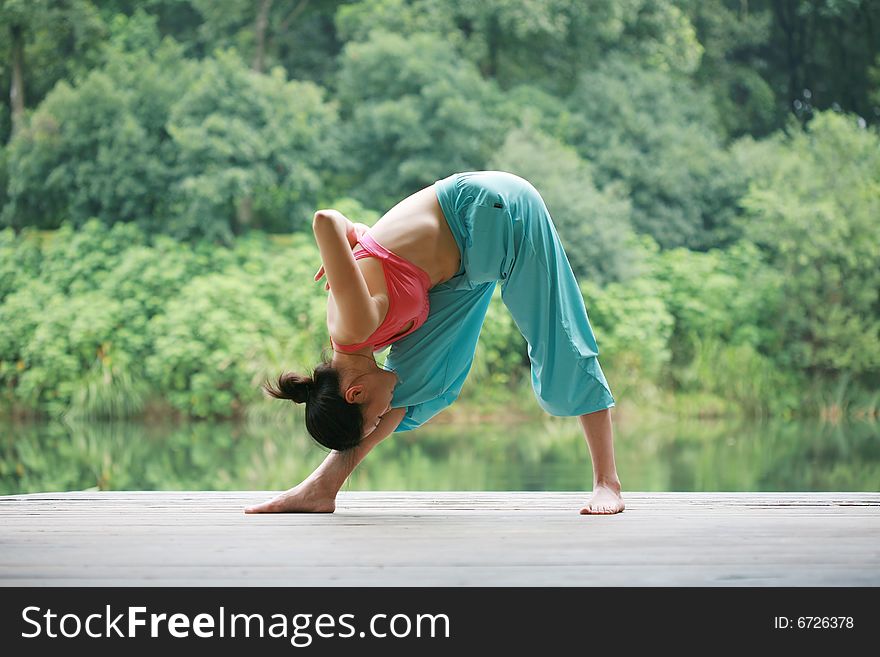 Young Chinese Woman Practicing Yoga Outdoor