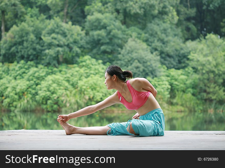 Young Chinese Woman Practicing Yoga Outdoor