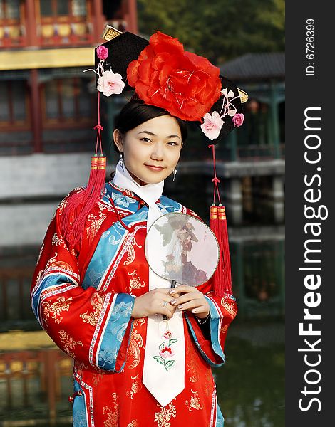 Portrait of a beautiful girl in Chinese ancient dress. 

Chinese on the fan is meant and missed. Portrait of a beautiful girl in Chinese ancient dress. 

Chinese on the fan is meant and missed.