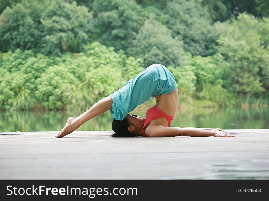 Young Chinese Woman Practicing Yoga Outdoor