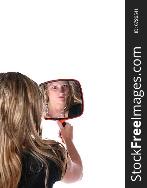 Pretty woman reflected in a hand mirror