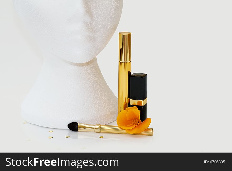 Female mannequin with lipstick, mascara and makeup brush. Clipping path and copy space included. Female mannequin with lipstick, mascara and makeup brush. Clipping path and copy space included.