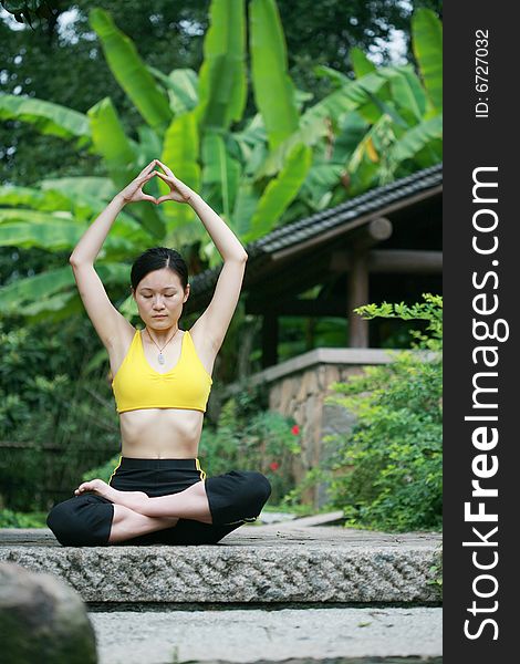 Young Chinese Woman Practicing Yoga Outdoor