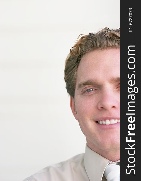 Businessman smiling and looking straight ahead with a business shirt on