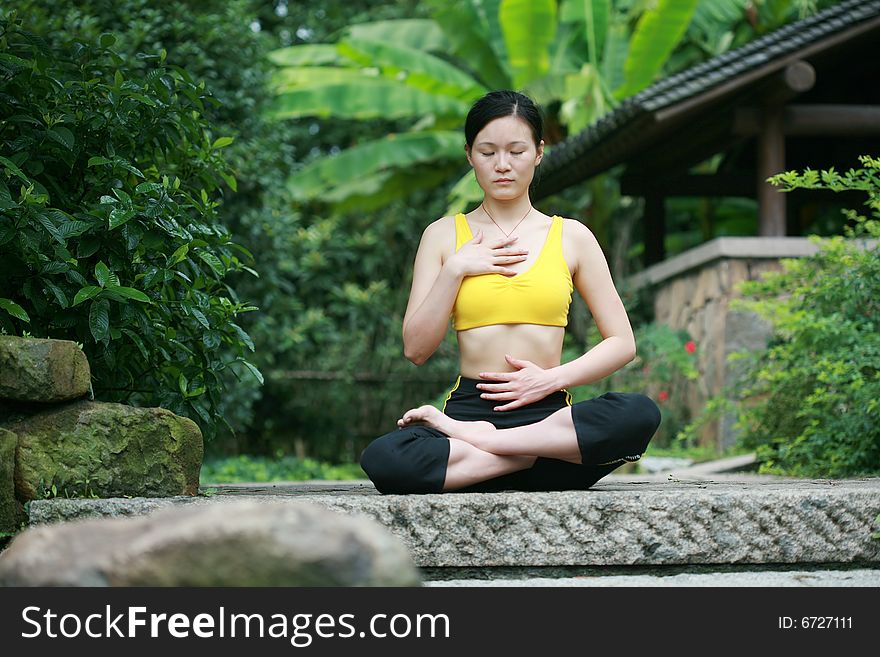 Young Chinese Woman Practicing Yoga Outdoor