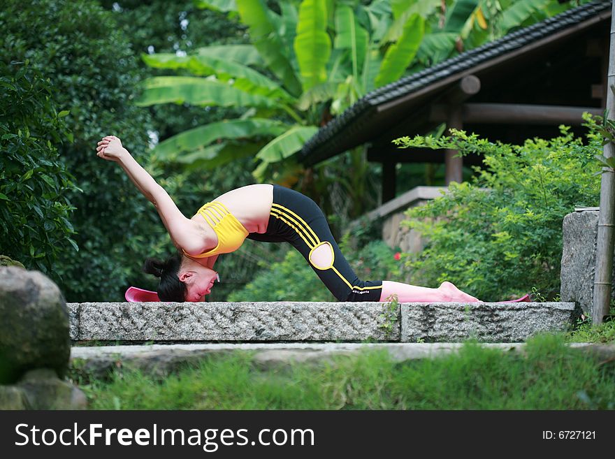 Young Chinese Woman Practicing Yoga Outdoor