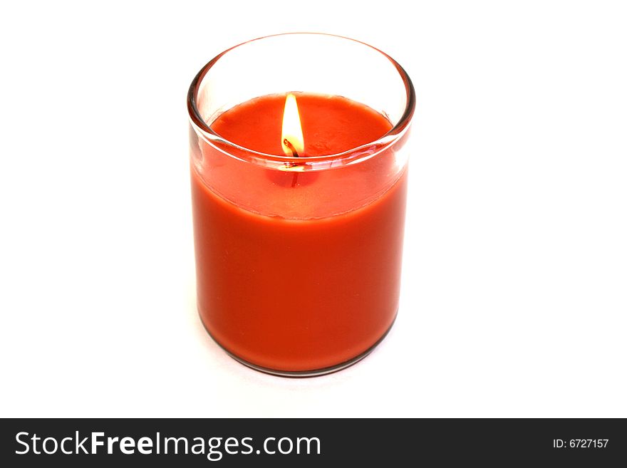 Orange candle with a vibrant flame