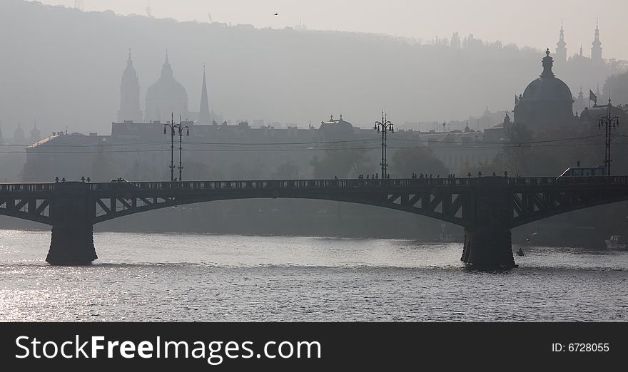 Foggy view to Little quarter and St. Nicholas church over Vltava river. Foggy view to Little quarter and St. Nicholas church over Vltava river.