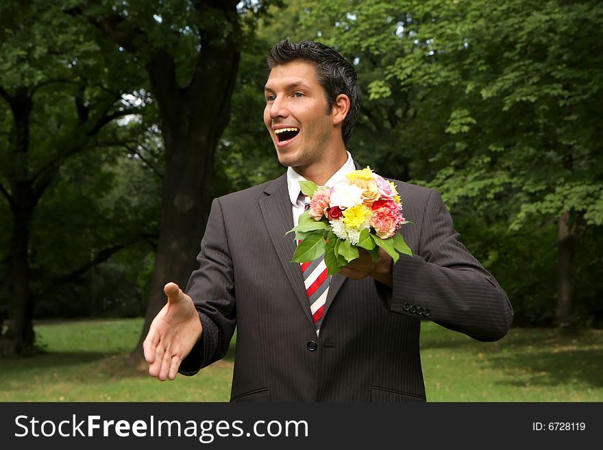 Man giving hand with a bouquet of flowers outdoor. Man giving hand with a bouquet of flowers outdoor