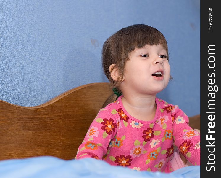 The little girl on a bed. The three-year child of the European nationality