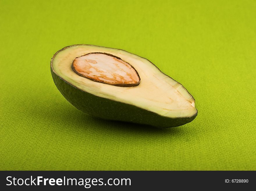 Avocado close-up isolated on green background