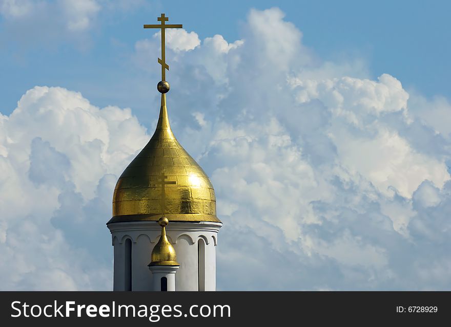 Gold church cupola on sky background