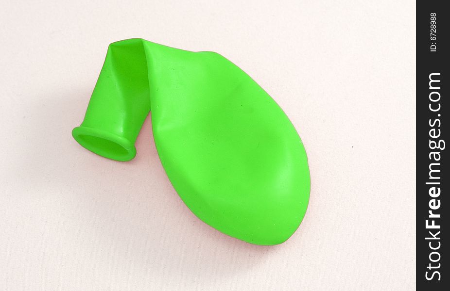 Green inflating balloon on a white background. Green inflating balloon on a white background
