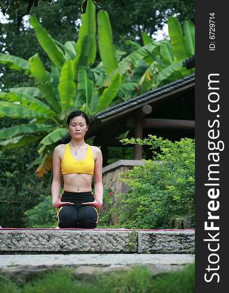 Young Chinese Woman Practicing Yoga Outdoor