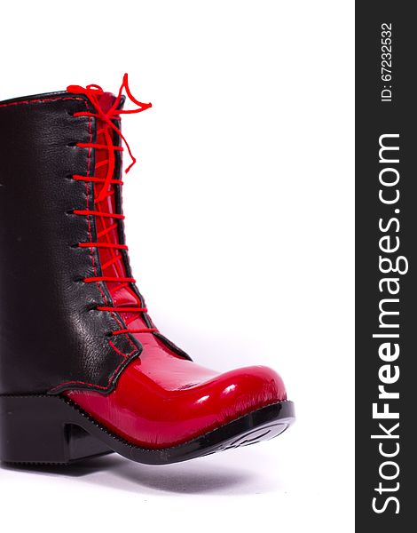 Black and red glossy women's boots on a white background. Black and red glossy women's boots on a white background