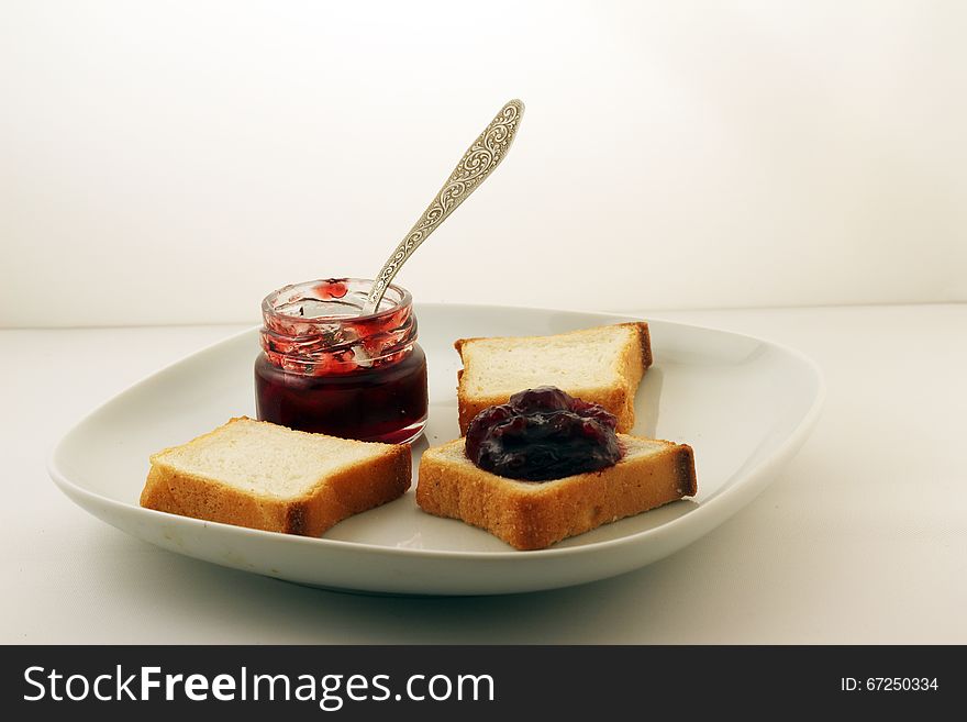 Jam And Bread On A White Plate