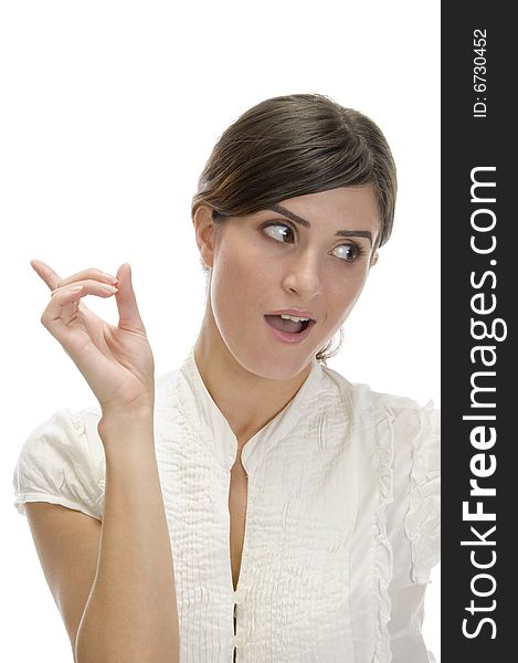 Pointing lady looking sideways against white background