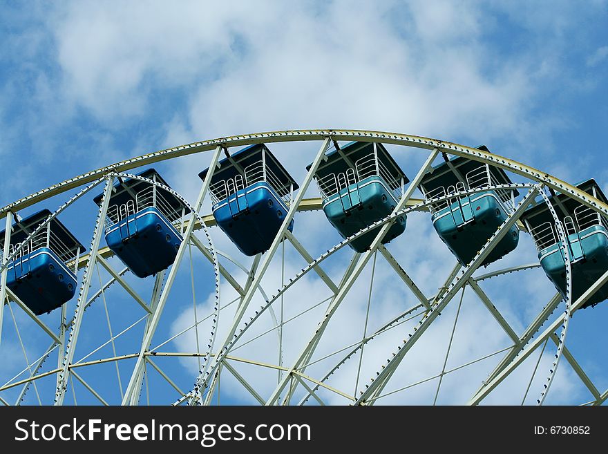 Ferris wheel against bule sky with clouds