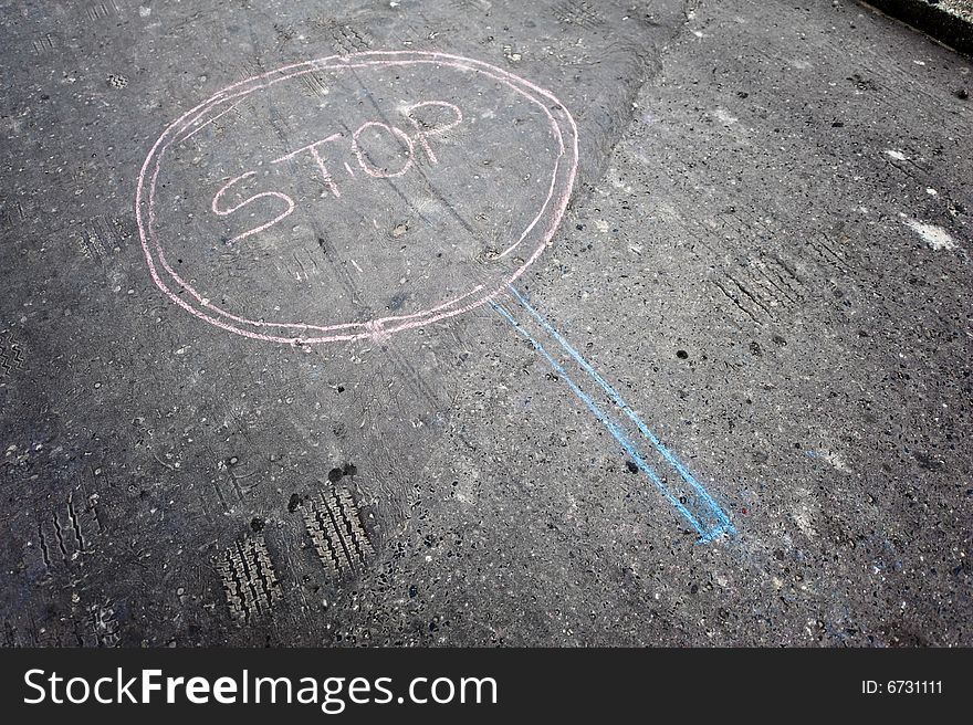 Stop sign made by kids by chalk on asphalt. Stop sign made by kids by chalk on asphalt