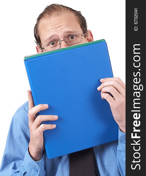 Young successful businessman wearing office clothes hiding behind the folder, looking terrified. Isolated on white background. Young successful businessman wearing office clothes hiding behind the folder, looking terrified. Isolated on white background