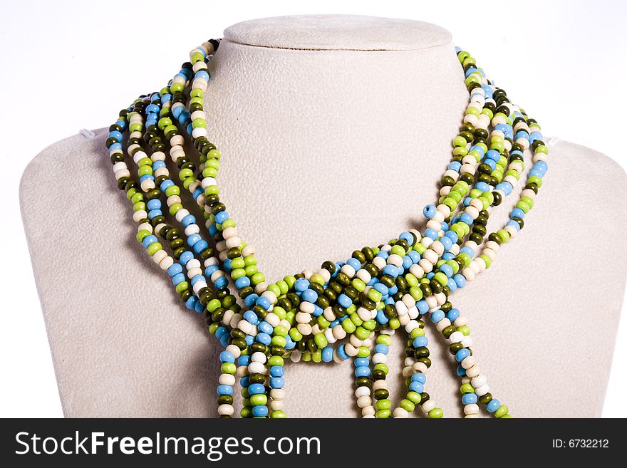 Colorful beads made necklace with self-standing display on white background