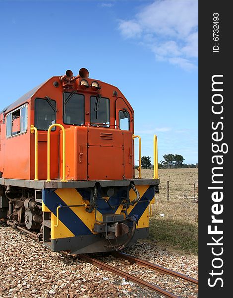 Orange train engine in the country side