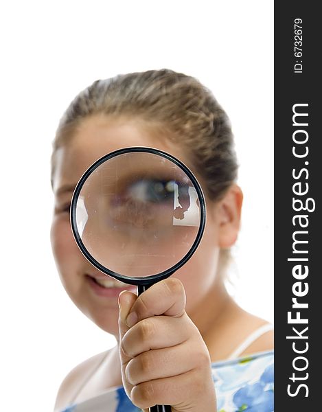 Girl looking through magnifier on an isolated background