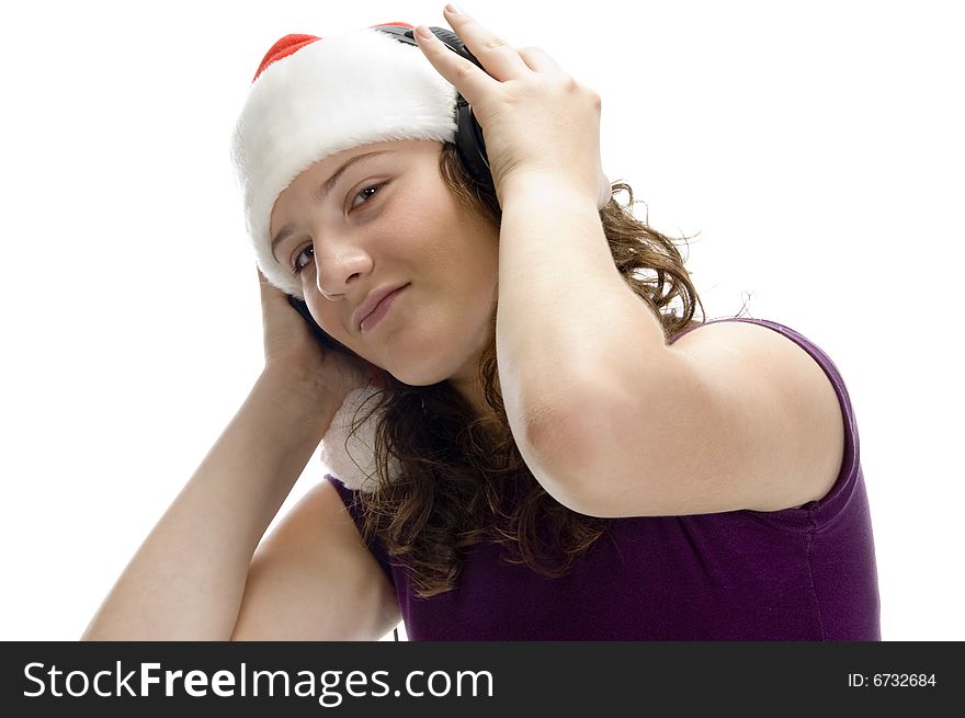 Woman listening through headphone against white background