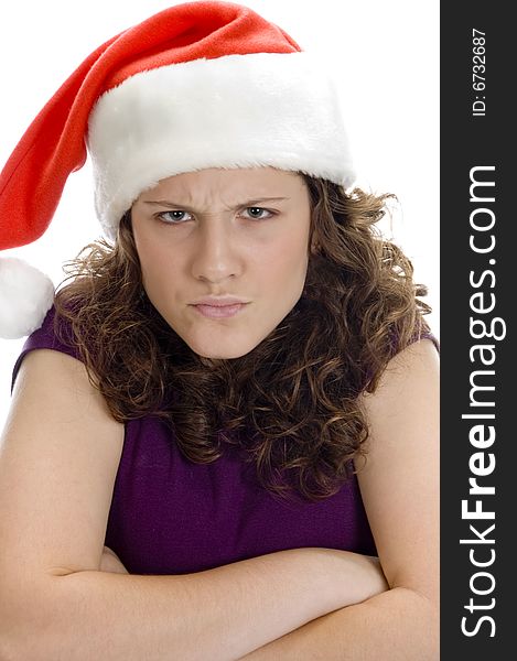 Young teenager angry with santa hat against white background