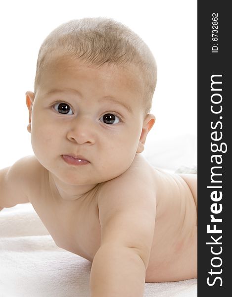 Happy child lying and looking at camera on an isolated white background