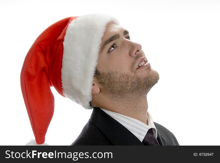Young man looking upside and wearing santa cap