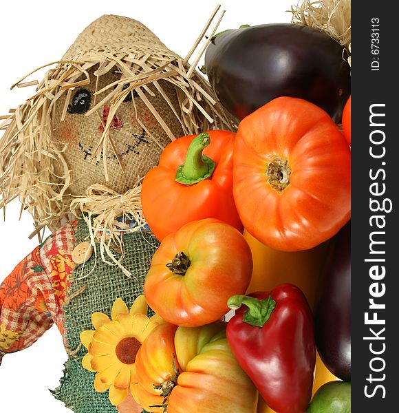 Scarecrow with vegetables on white isolated