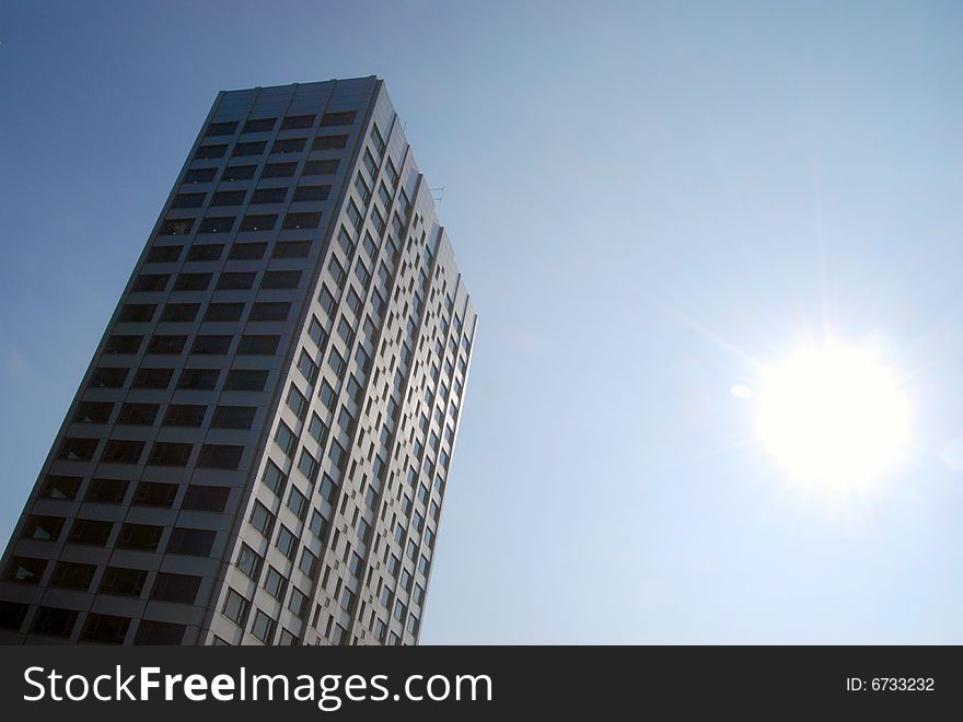 Dynamic view of office block against cloudless blue sky. Dynamic view of office block against cloudless blue sky
