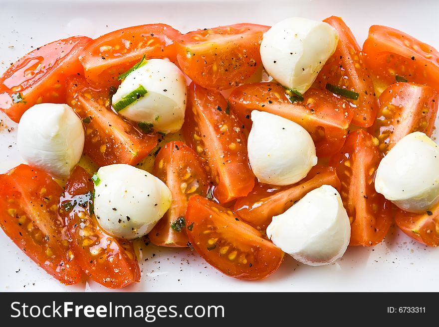 Tomato and mozzarella on a white plate