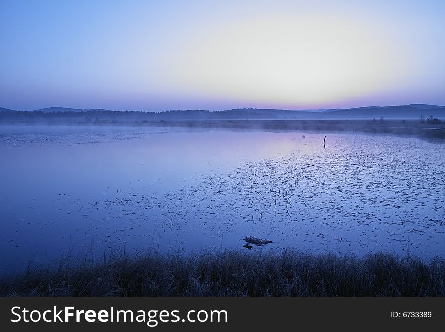 An early and cold morning of a lake in a deep autumn. An early and cold morning of a lake in a deep autumn.