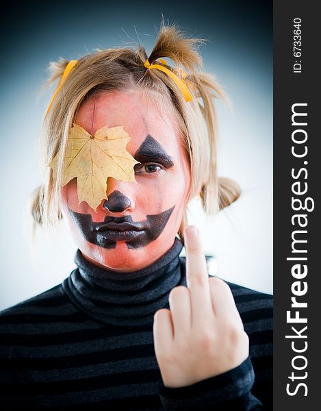 Upset Jack-o-lantern girl with leaf on face