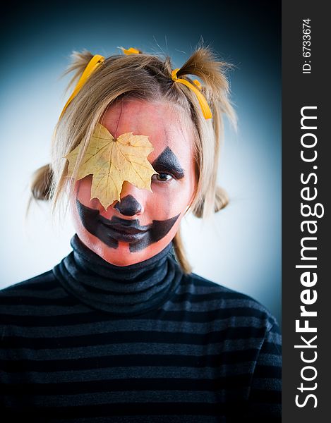 Smiling Jack-o-lantern girl with leaf on face