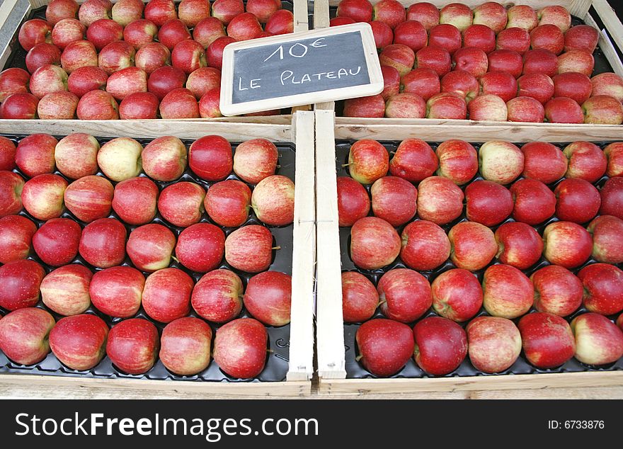 Rows of fresh red apples on display on French market