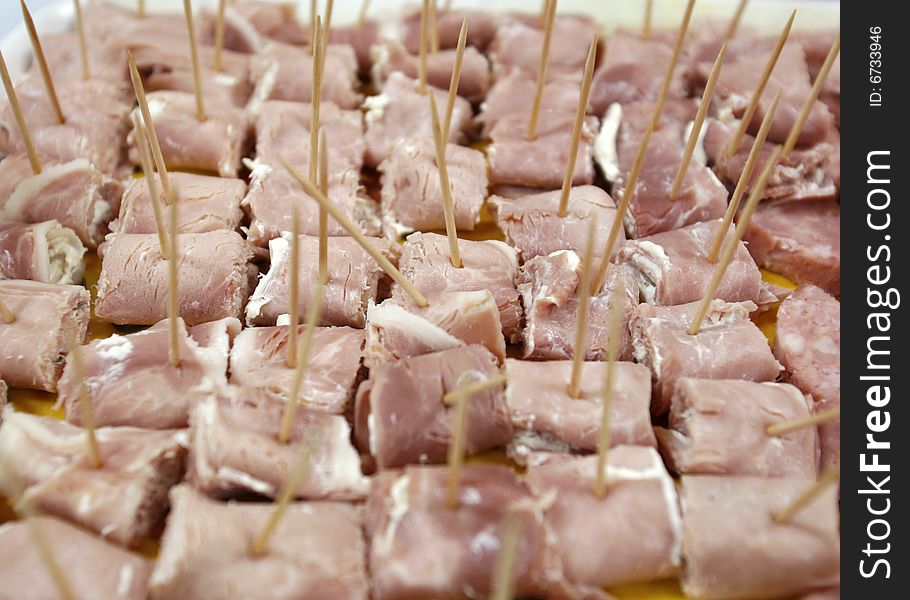 Sliced ham and tooth picks as finger food at party