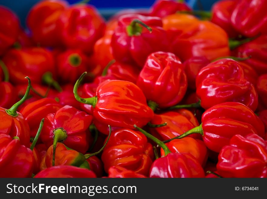 A box of red peppers on a food market. A box of red peppers on a food market.