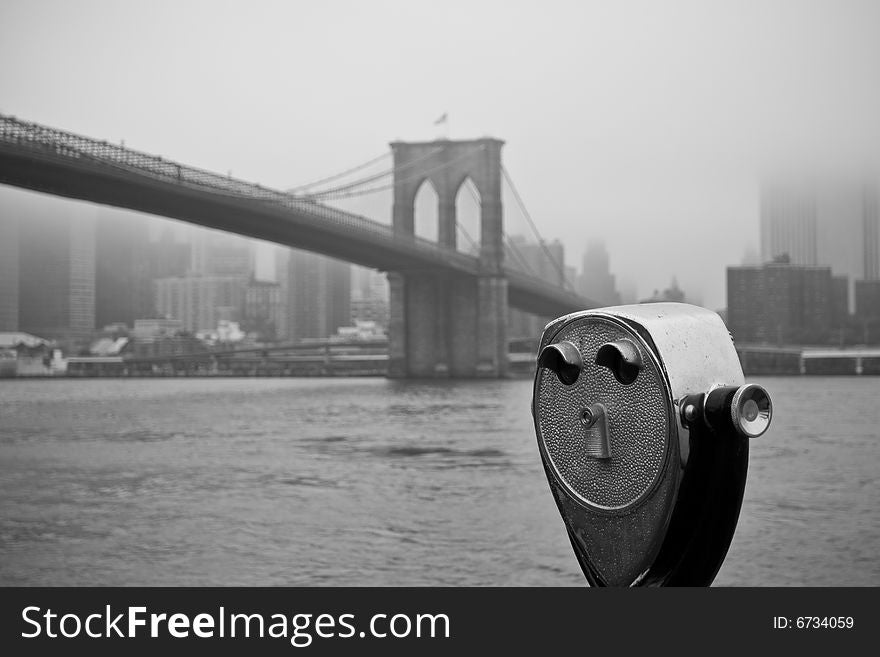 View on a telescope in front of the East River on a foggy autumn day. View on a telescope in front of the East River on a foggy autumn day.