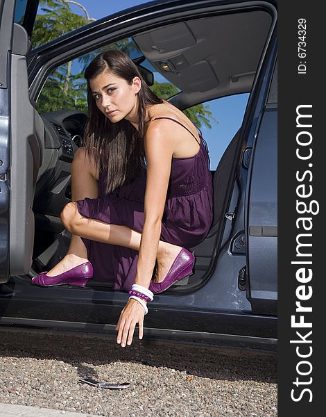 Young women with pink dress on her car. Young women with pink dress on her car