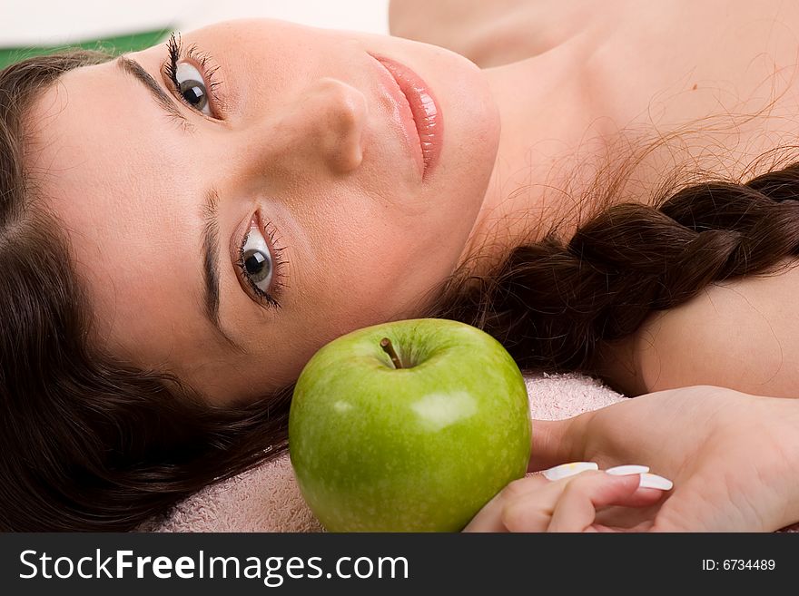 Beautiful young woman in towel holding green apple. Beautiful young woman in towel holding green apple