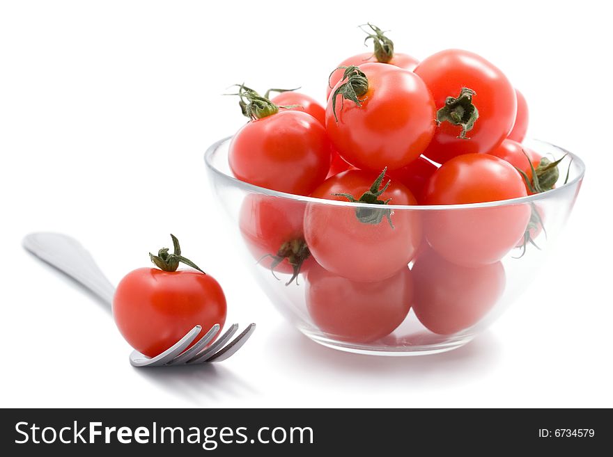 Ripe tomatoes cherry isolated in glass bowl. Ripe tomatoes cherry isolated in glass bowl
